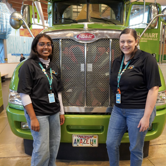 Amazeum Employees Posing In Front of Semi Truck