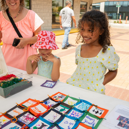 Girl In Front Of Paper Quilt