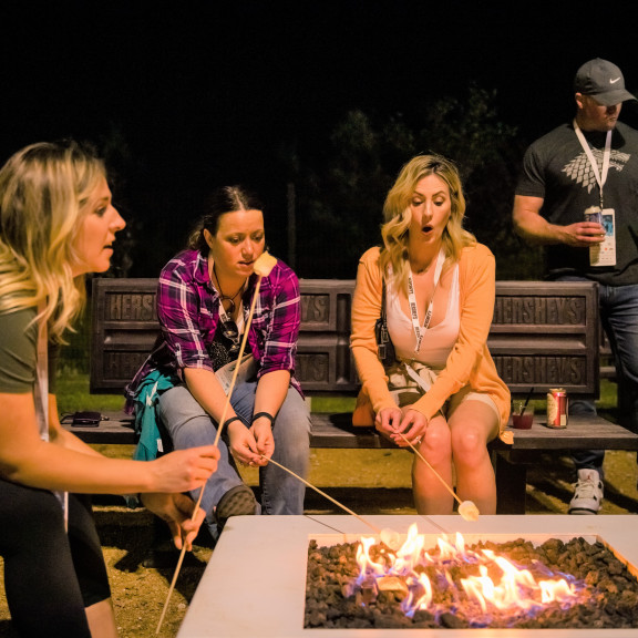 Three Women Making Smores At The Hersheys Campfire