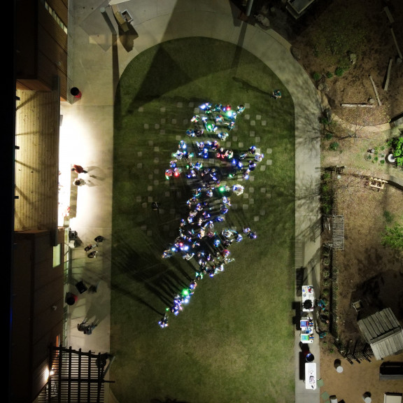 Overhead Shot of People Forming a Zing Lightning Bolt