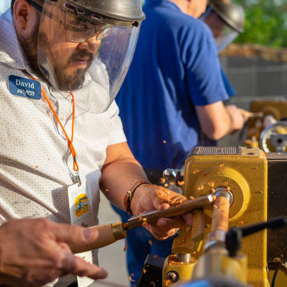 Person Using Wood Lathe To Make a Project