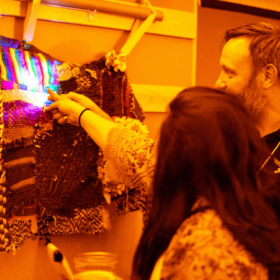 Two Adults Interacting With Light Exhibit