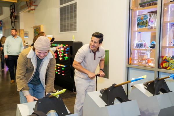 Two People Playing With Fake Rocket Launching Exhibit