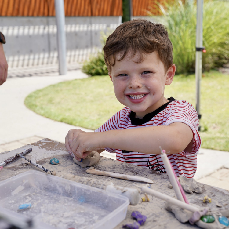 Young Boy Working With Clay At Table