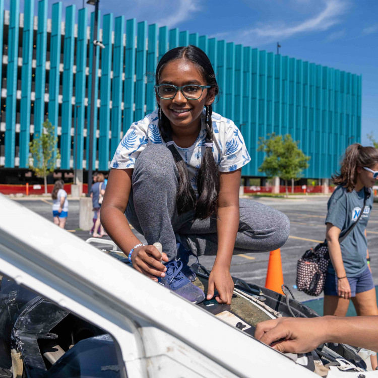 Young Girl Helping Disassemble Vehicle