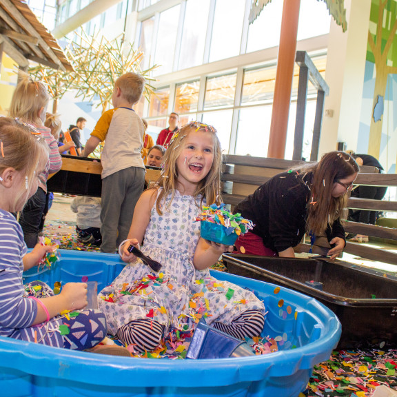 Children In A Kiddie Pool Full of Confetti