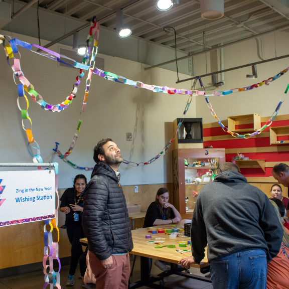 People Making Paper Links For Zing Wishing Station