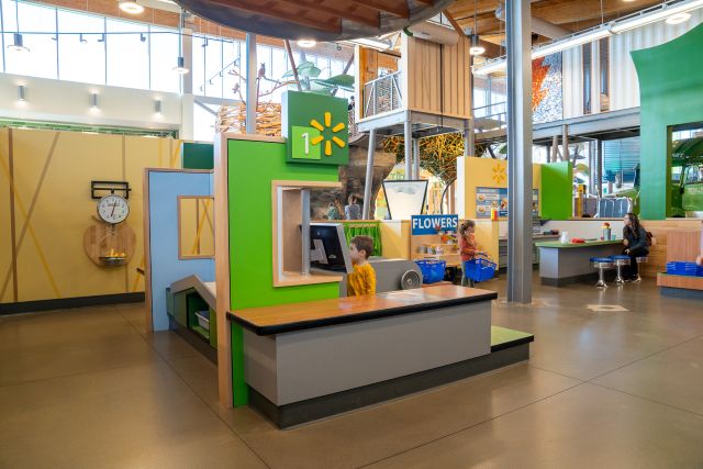 Boy Using Cash Register At Walmart Market Experience