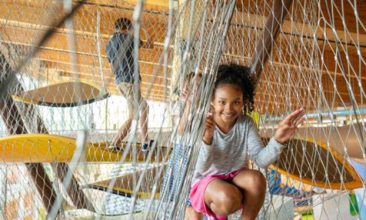 Girl Playing in Ropes of Canopy Climber