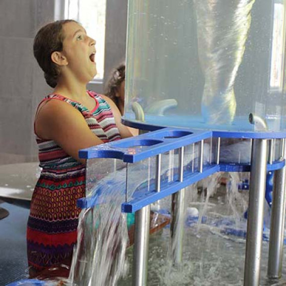 Girl Staring At Whirlpool In Tank