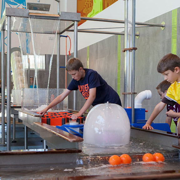 Older Boy Doing Experiments On Water Experiment Table