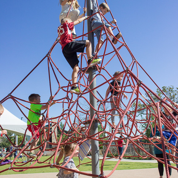 Children Playing On Outdoor Playscape