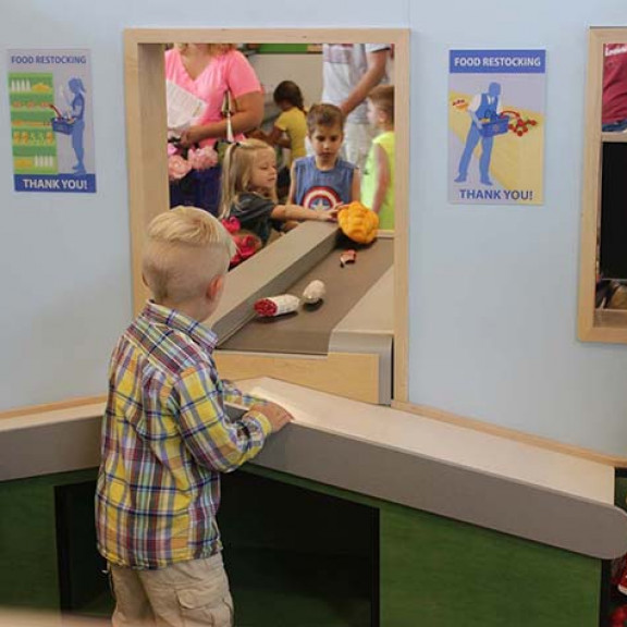 Children Playing With Cashier Conveyor Belt At Walmart Market Experience