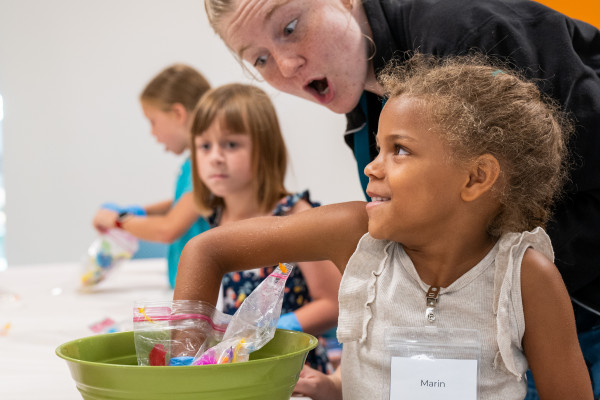 Young Girl Grabbing Into A Bag Of Project Parts