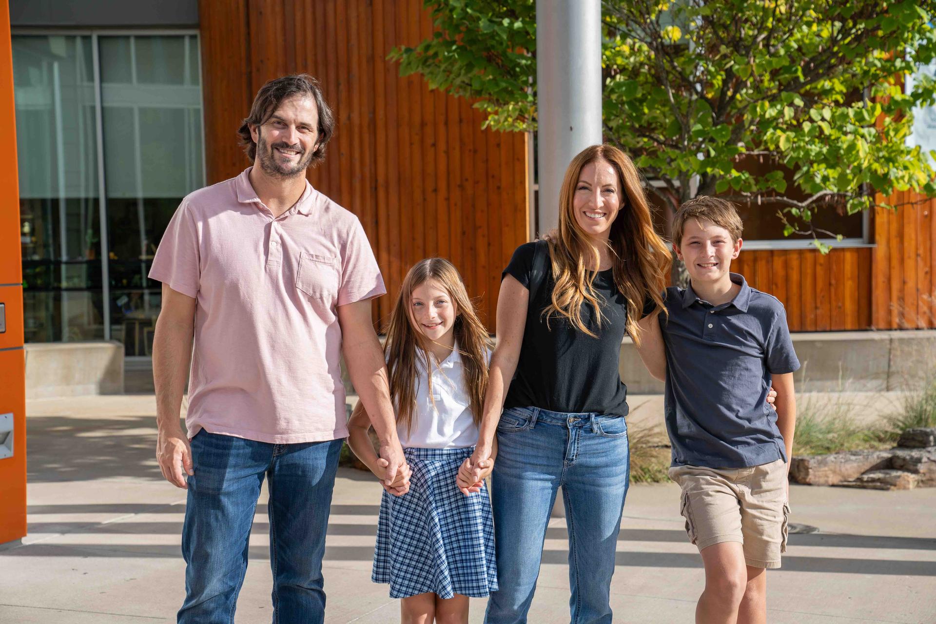 Family Posing In Front Of Amazeum