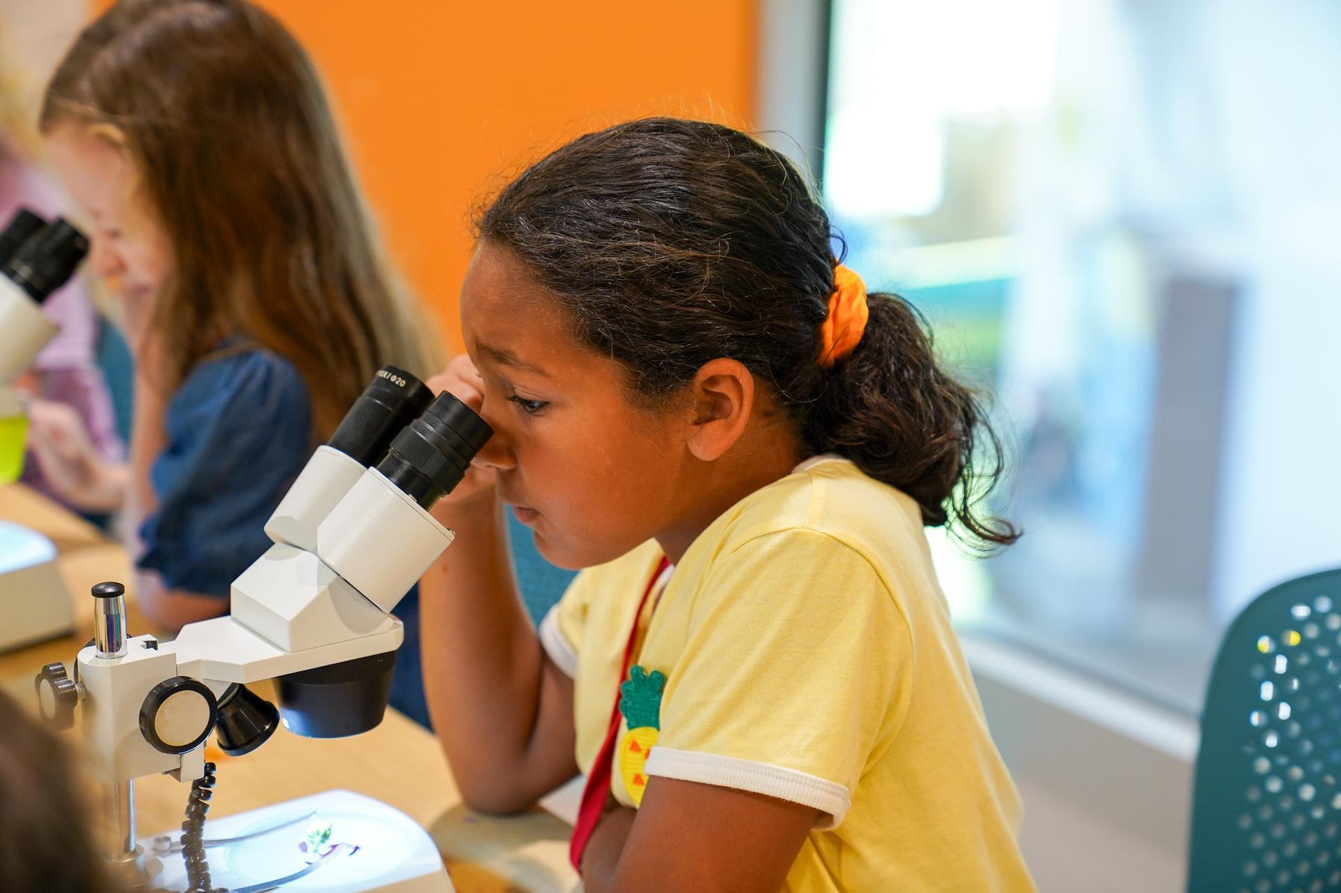 Young Girl Using Microscope