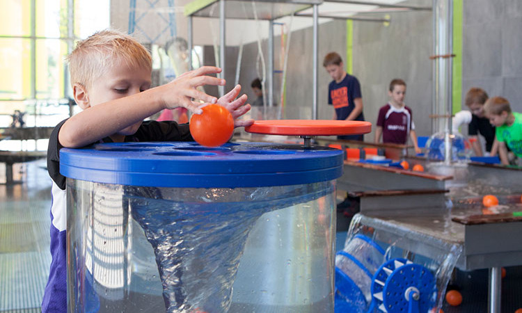 Boy Playing With Ball And Whirlpool At Nature Valley Water Exhibit