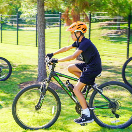 Boy In Blue Shirt Riding Bicycle Outside Amazeum