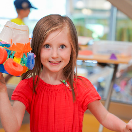 Girl In Red Shirt Posing With Her Pool Noodle Artwork