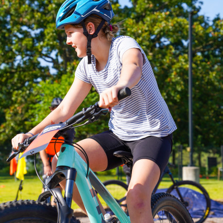 Girl In Striped Shirt Riding Her Bicycle