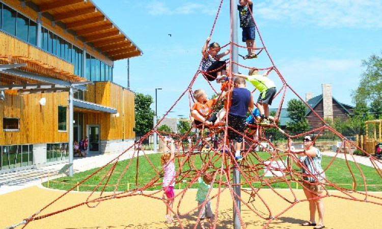 Children Playing On Outdoor Playscape