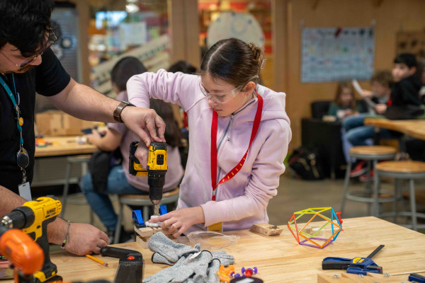 Teen Girl Using Power Drill To Make Her Project