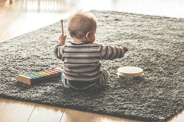 Partners In Play Baby Sitting On Carpet