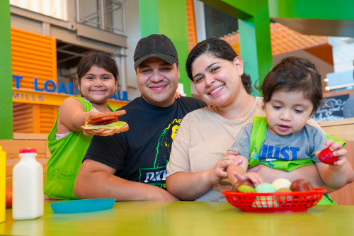 Family Smiling And Playing In Walmart Market Exhibit